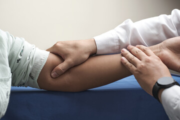 doctor's hands palpating brachial pulse of unrecognizable African-American woman