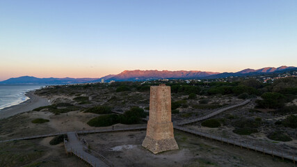 Fototapeta na wymiar amanecer en la playa de Cabopino y las dunas de Artola junto a torre ladrones, Marbella