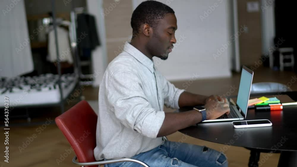 Poster african american male freelancer using laptop computer for browsing website and doing remote working
