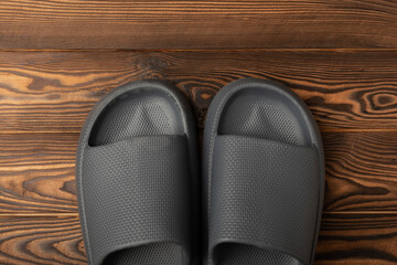 Rubber summer slippers. Replacement shoes for home or office. Yellow slippers on a background of brown space. Relax concepts. Space for text.Space for copy.