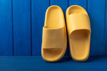 Yellow rubber summer slippers. Replacement shoes for home or office. Yellow slippers on a...