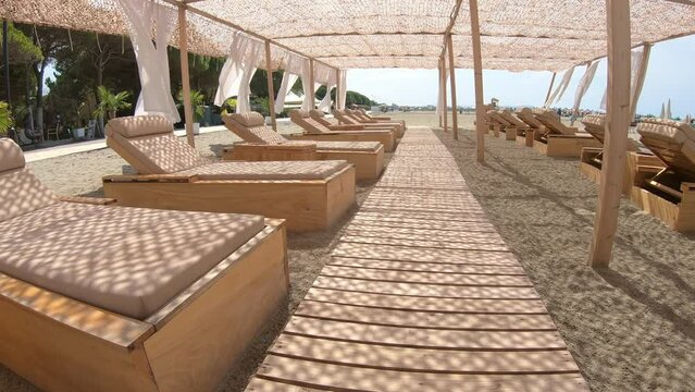 Suumer vacation luxury resort white tent on a sandy beach against the background of blue sunny sky