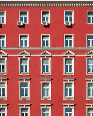 Fototapeta na wymiar Red painted facade of a classical building