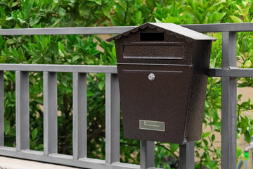 Metal fence with mailbox outdoors, closeup