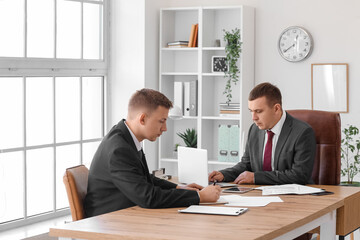 Business men working at table in office