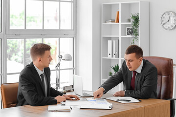 Business men working with documents at table in office