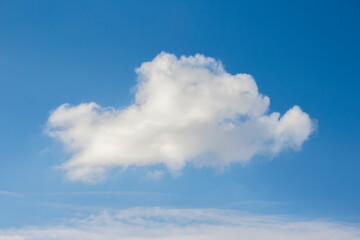 Naklejka na ściany i meble A white cloud in a blue sky