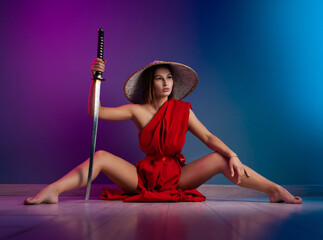 sexy woman in a red cape and an Asian hat with a katana in her hand image of a samurai in neon color