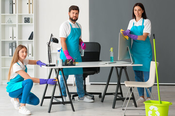 Young janitors cleaning in modern office
