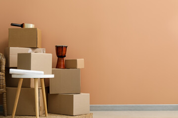 Moving cardboard boxes with table near color wall