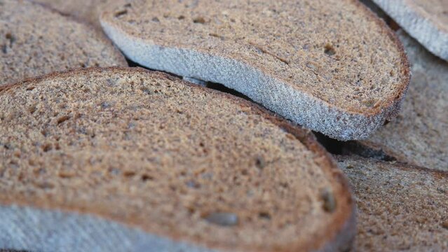 There are many pieces of stale bread in the breadbasket. Food losses and food waste. Spoiled extra bread