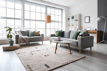 Interior of modern living room with grey sofas, window and shelving unit
