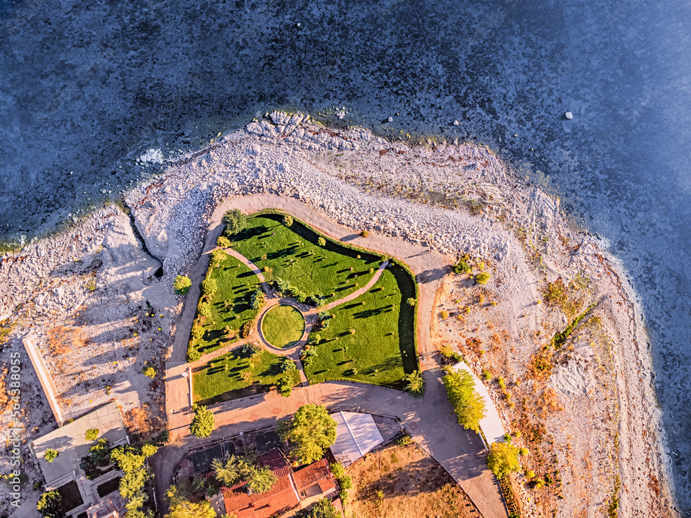 Wall mural aerial rooftop cityscape view of a resort old town and blue sea or lake in the background