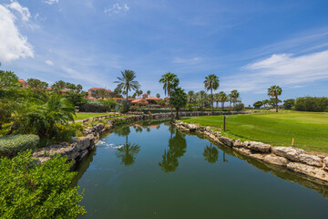 Fototapeta na wymiar Beautiful view of lake on the golf courses on sunny day. Aruba.
