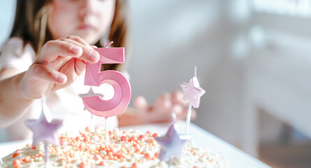 Big pink 5 number candle on homemade cake. Creative congratulations on five years for child girl....
