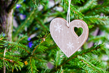 A miniature wooden heart with a small heart-shaped cutout and a snowflake decoration
