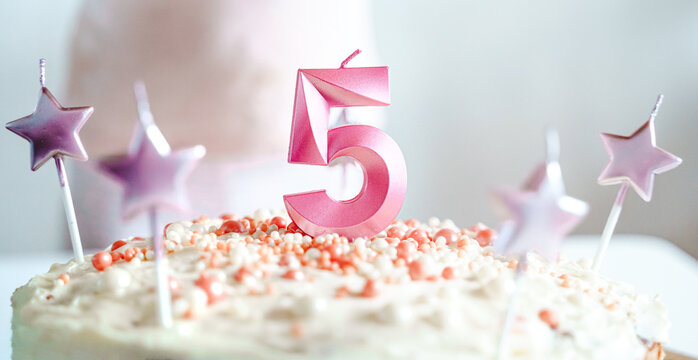 Big pink 5 number candle on homemade cake. Creative congratulations on five years for child girl. Festive decoration for 5th birthday, topping, dressing. Merry home holiday, party with mom, family