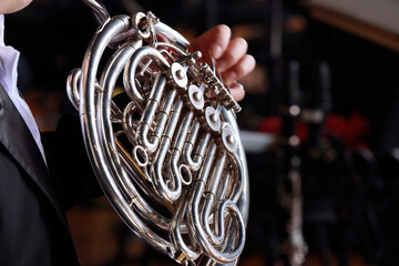 Musician playing the horn during a symphony concert