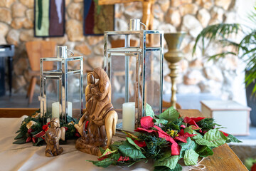 Church decoration for Christmas. Figurine of the Virgin Mary on a donkey and angels. Lamp on the...