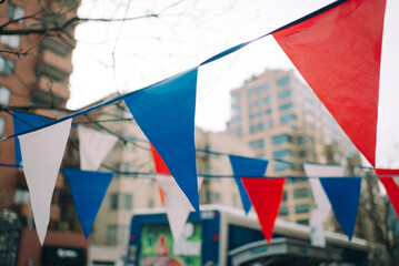 Triangle decorative flag hang in front of a business during Independence Day in New York