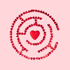 Love maze made of red hearts on pastel light pink background. Modern Valentine's Day concept. Creative love idea.