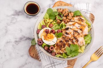 Green salad with baked chicken breast