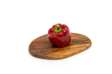 Pepper on wooden chopping board on white background isolated