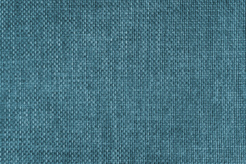 Jacquard woven upholstery, turquoise coarse fabric texture. Textile background, furniture textile material, wallpaper, backdrop. Cloth structure close up.