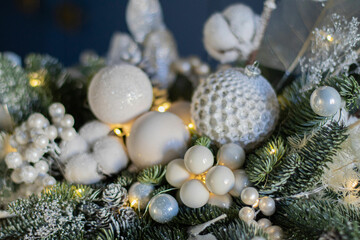 Beautiful winter Christmas floral composition of fresh Nobilis in hat box in blue backgraund. Cotton, spruce, sparkling ornaments. Holiday concept. Happy New Year decorations.