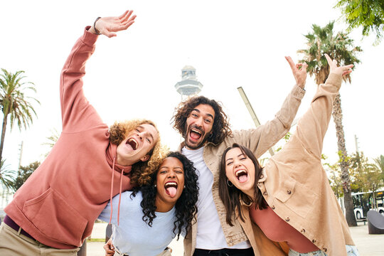 Fool around portrait of a cheerful young friends. Happy people goofing off having fun. Concept of community, youth lifestyle and friendship. High quality photo