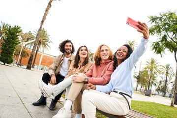 Beautiful woman taking selfie with a friends. Group of multi-ethnic young people - happy smiling selfie. High quality photo