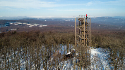 Aerial view of wooden lookout tower on the top of Velka Homola in winter, Male Karpaty, Slovakia
