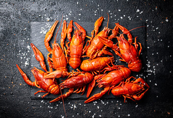 Boiled crayfish on a stone board with salt. 