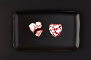 red cookies with cracks in the shape of a heart for valentine's day on a black background