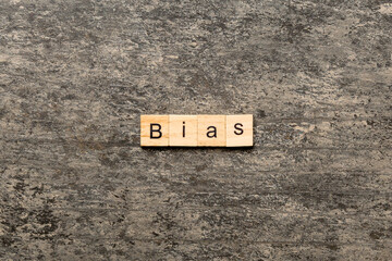 BIAS word written on wood block. BIAS text on cement table for your desing, concept