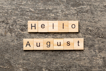 Fototapeta premium hello august word written on wood block. hello august text on table, concept