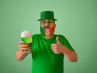 St. Patrick's Day celebration. A man with a beard, glasses and a leprechaun hat raises a toast to...