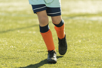Fototapeta premium leg children run play soccer orange footwear grass stadium