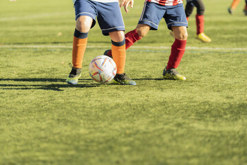 Obraz premium youth football match image half lower body. concept sport