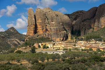 Famous climb walls mountains of Mallos de Agüero (Aguero cliffs) in Huesca and the Agüero village in the foreground.