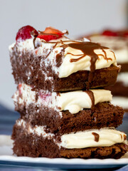 Sweet and delicious chocolate cake with whipped cream and strawberries and raspberries.