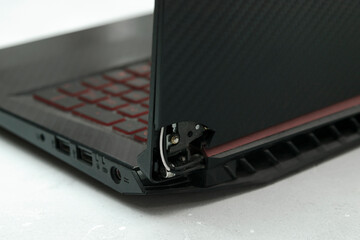 Laptop is broken with arm hinge on the screen,laptop cover,repair loop. cracked plastic laptop...