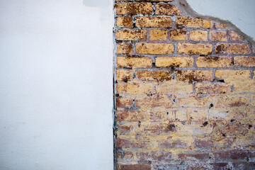 Close up stucco and exposed brick wall