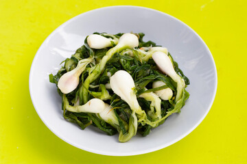 Pickled spring onion in white plate