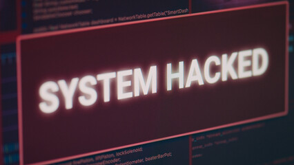 Hacked system alert message flashing on computer screen, showing security breach error and cyber crime attack. Monitor displaying system error security and computer malfunction. Close up.