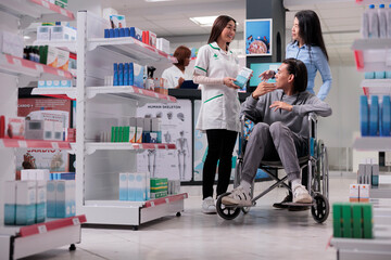 Young adult wheelchair user talking to specialist about healthcare products, looking to buy...