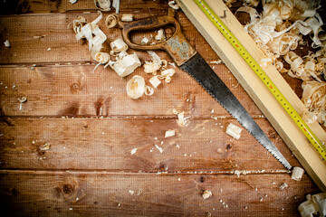 Hand saw with wooden shavings. 