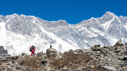 Porter in front of Lhotse wall, Everest Base Camp trek, Nepal