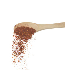 Red Hot Chilli fall, red grain chilli explode abstract cloud fly from wooden spoon. Beautiful complete seed chilly, food object design. Selective focus freeze shot white background isolated