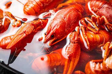 Crayfish are boiled in a pot in water. 